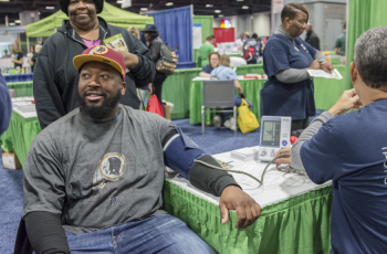 renin Jones getting his blood pressure taken at the GW Ron and Joy Kidney Center Transplant Institute booth at the NBC4 Health and Fitness Expo on January 19, 2015